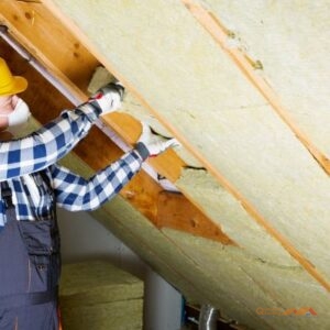 contractor installing attic insulation between rafters