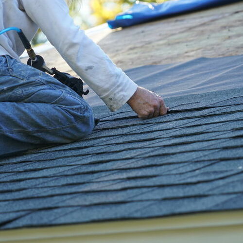 A Roofer Puts in Shingles.