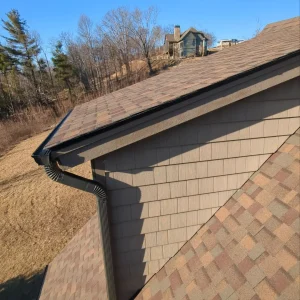 New asphalt roof shingles on a brown home