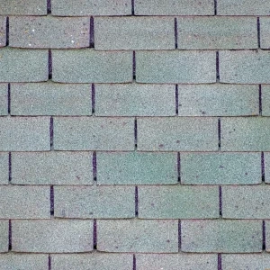 Hail damage pockmarks on asphalt shingles.