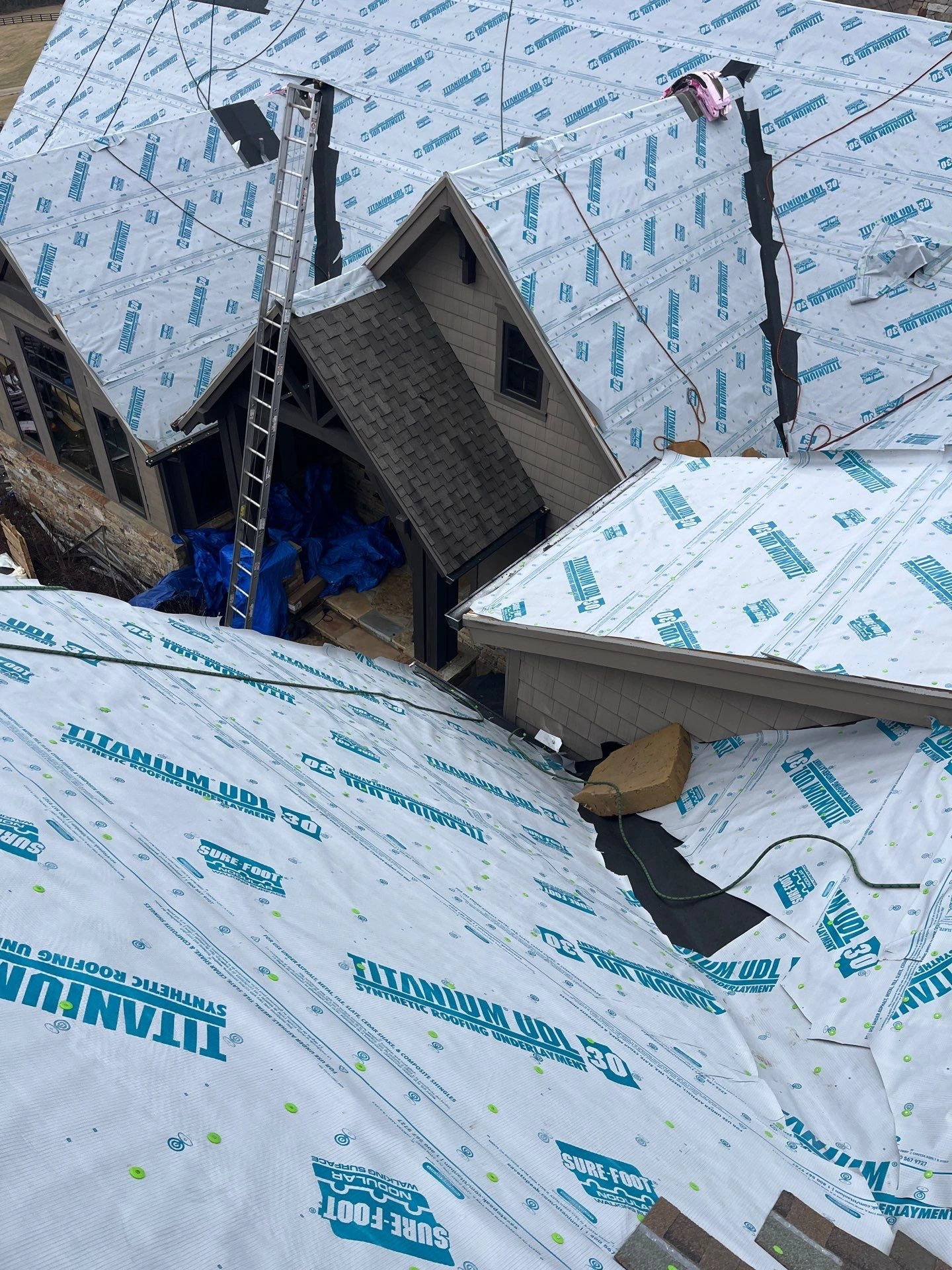 Rooftop view of a complex, multi-surfaced roof that requires much knowledge & experience from a professional roofer to complete a reroofing job