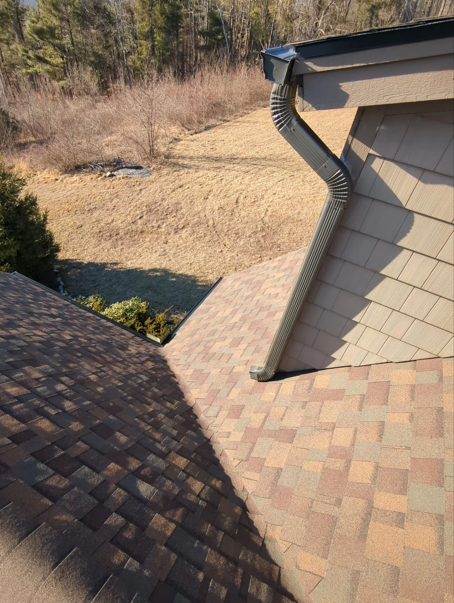 Rooftop view of a shingle roof that is finished after reroofing