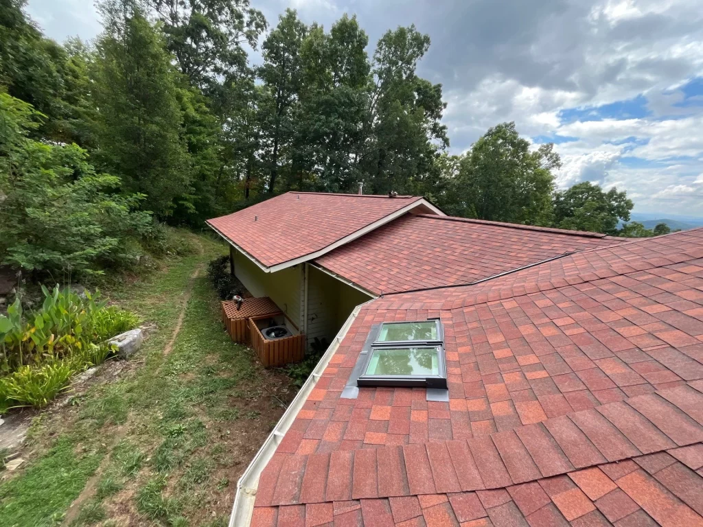 View of a roof with a skylight showcasing a recently completed skylight repair project.